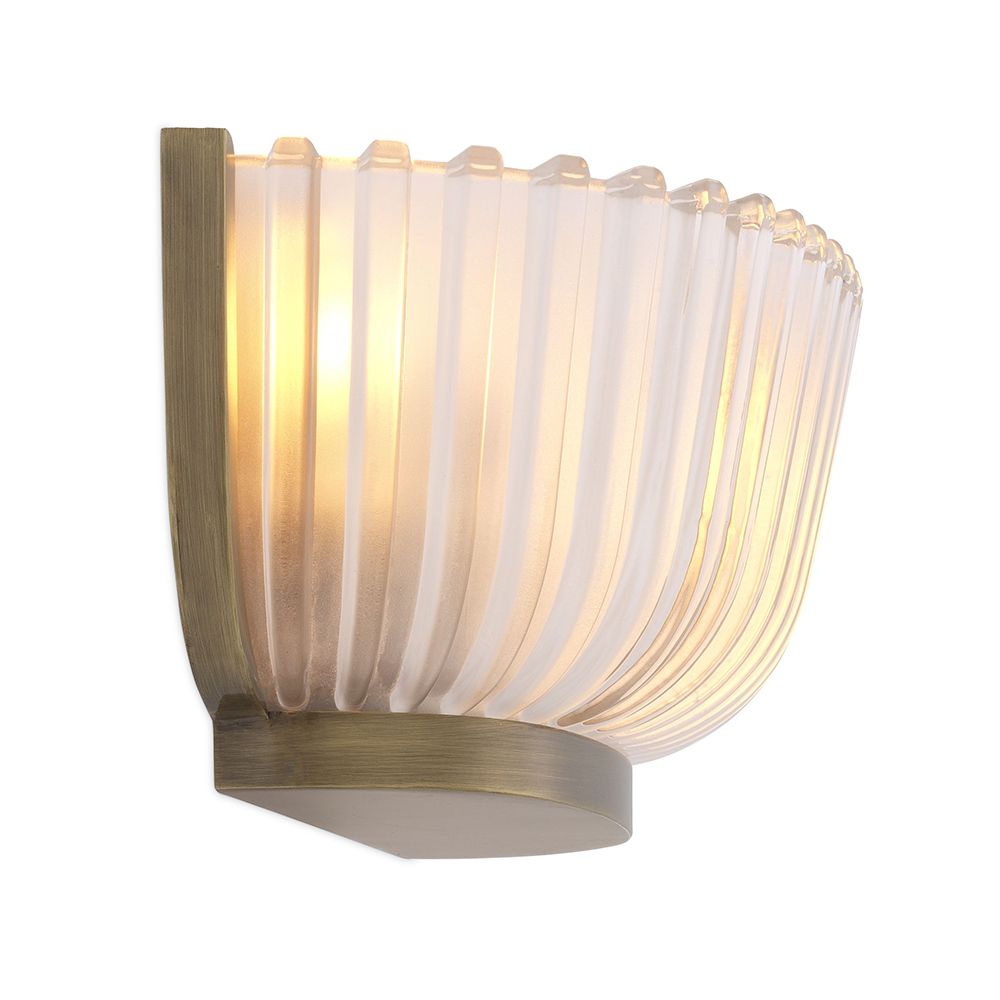 A luxurious wall lamp by Eichholtz featuring a frosted glass shade with vertical lines and a vintage brass finish