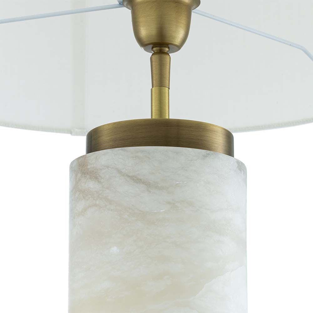 A gorgeous table lamp with brass accents and round shade
