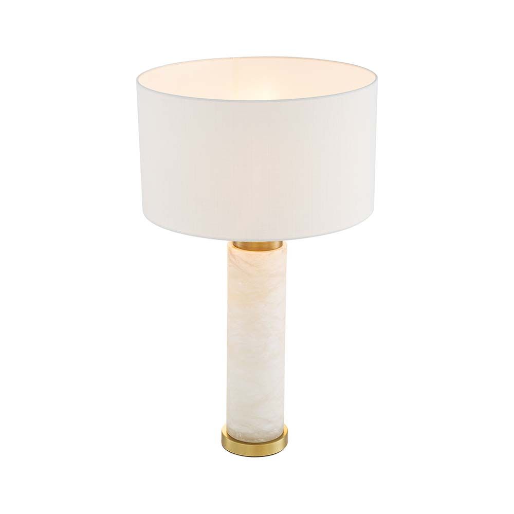 A gorgeous table lamp with brass accents and round shade