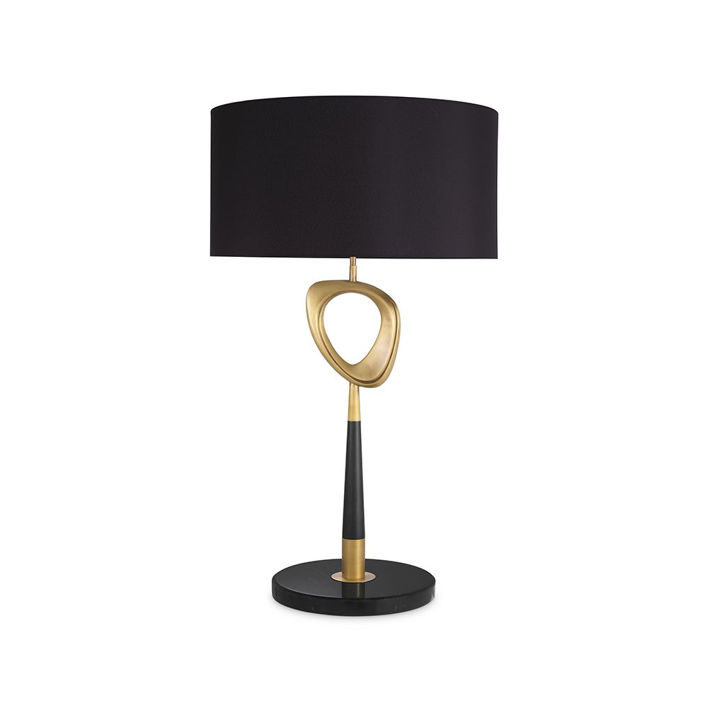 A contemporary table lamp by Eichholtz with a stylish design featuring an antique brass finish, an open free shape and a black cylindrical shade