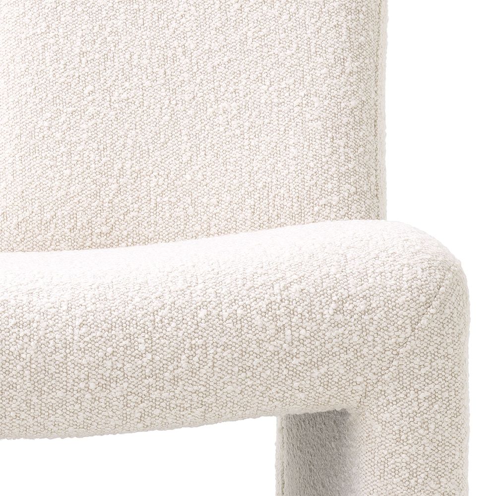 A contemporary modern chair by Eichholtz with a bouclé cream upholstery and original shape 