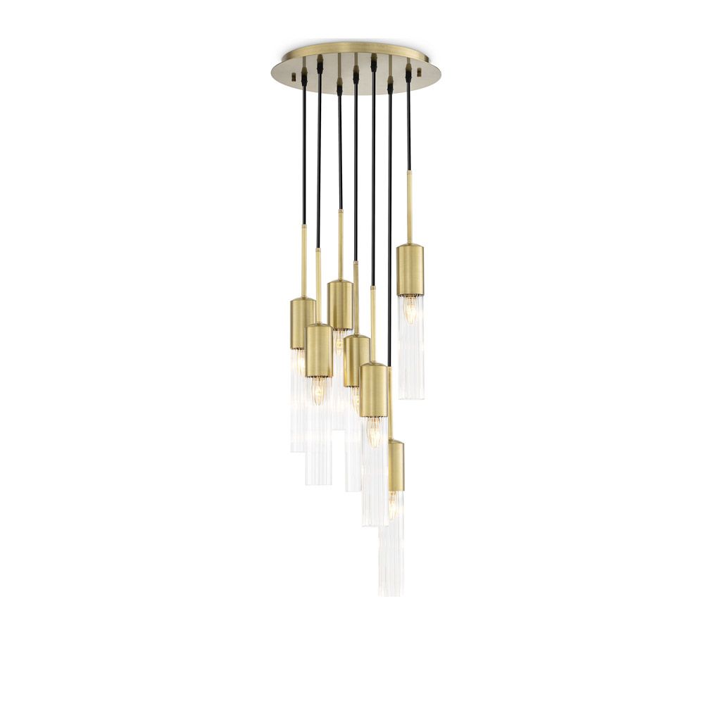 A stylish statement chandelier by Eichholtz with glamorous, cylindrical ribbed glass shades with an antique brass finish 