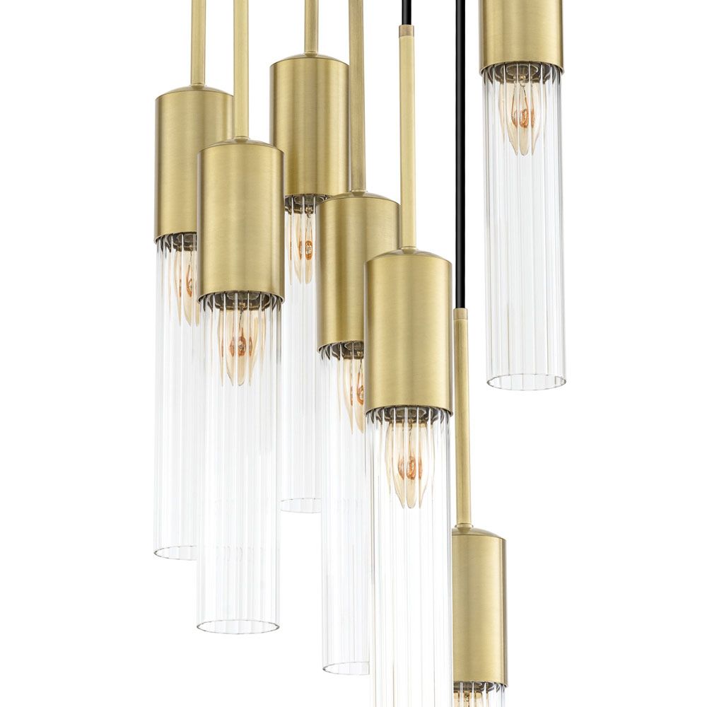 A stylish statement chandelier by Eichholtz with glamorous, cylindrical ribbed glass shades with an antique brass finish 