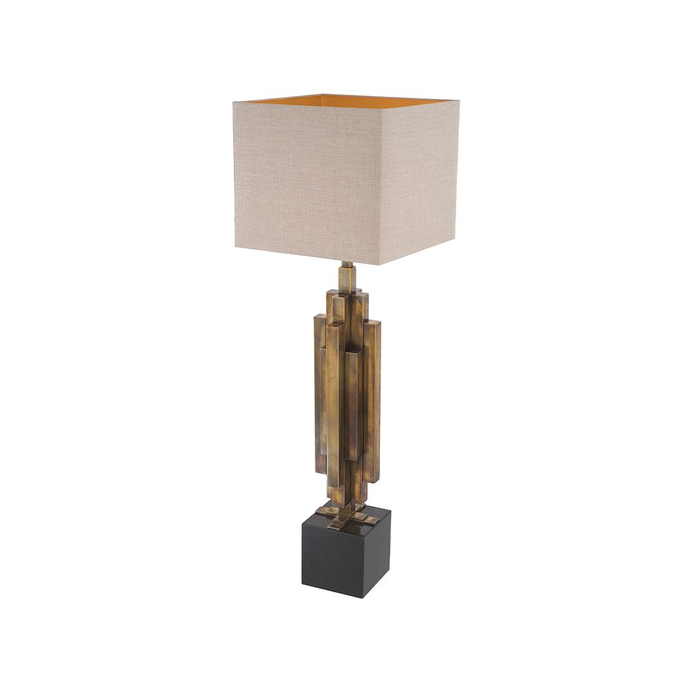 A stylish table lamp by Eichholtz with a structural design, stainless steel composition and vintage brass finish