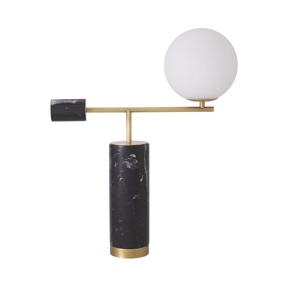 A striking, sculptural side lamp by Eichholtz crafted from black marble and finished with a spherical white glass shade and antique brass details