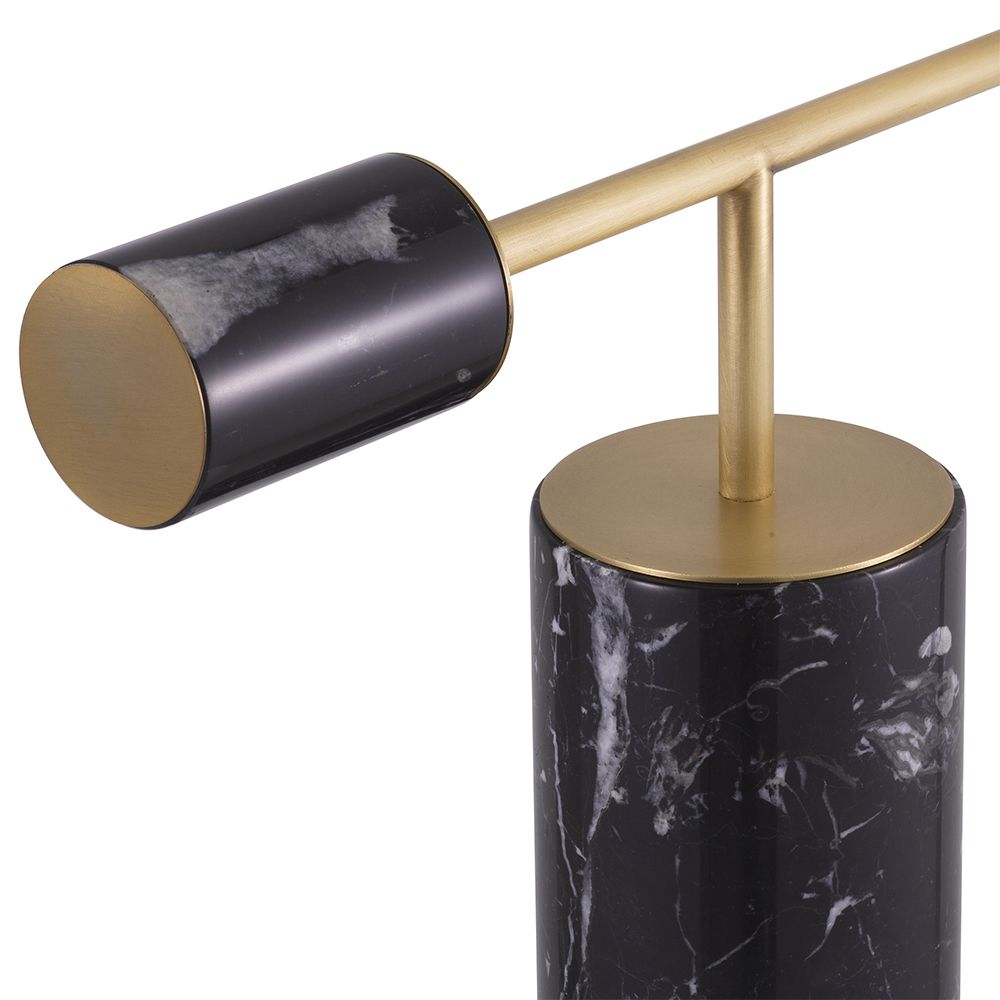 A striking, sculptural side lamp by Eichholtz crafted from black marble and finished with a spherical white glass shade and antique brass details
