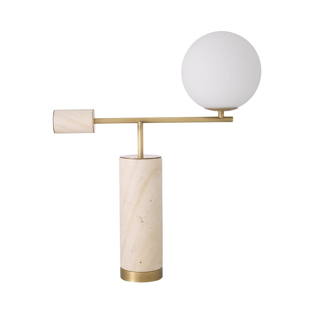 A sculptural side lamp by Eichholtz crafted from travertine with a spherical white glass shade and antique brass finish