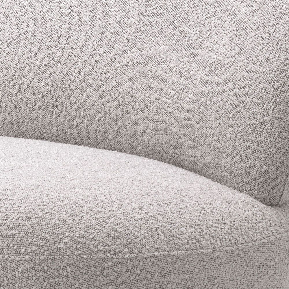 Curvaceous grey boucle swivel chair with brushed brass base