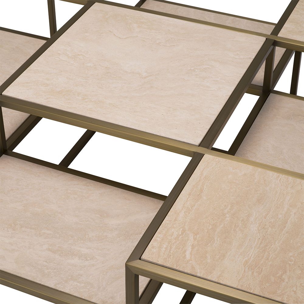 A contemporary coffee table by Eichholtz with a sculptural design featuring a brushed brass finish and travertine table tops