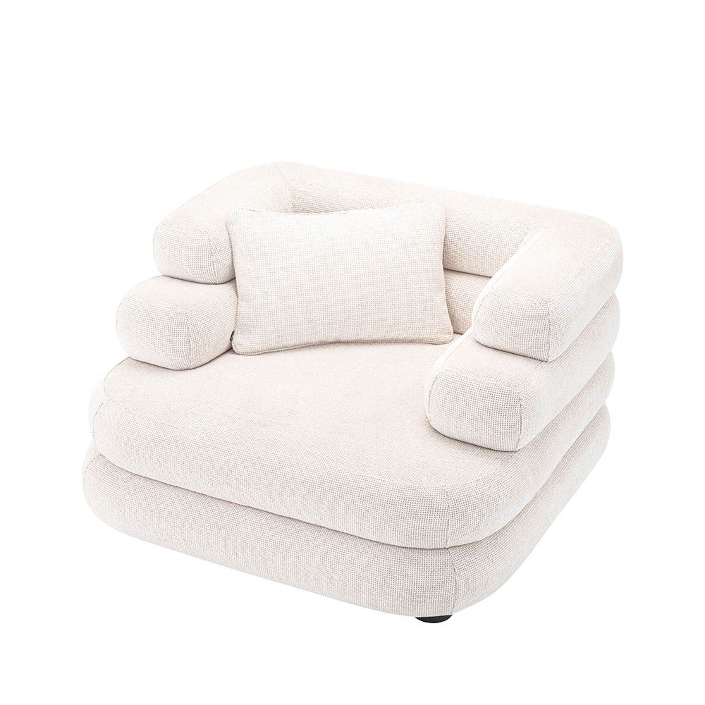 Luxurious armchair with sumptuous upholstery and rounded design