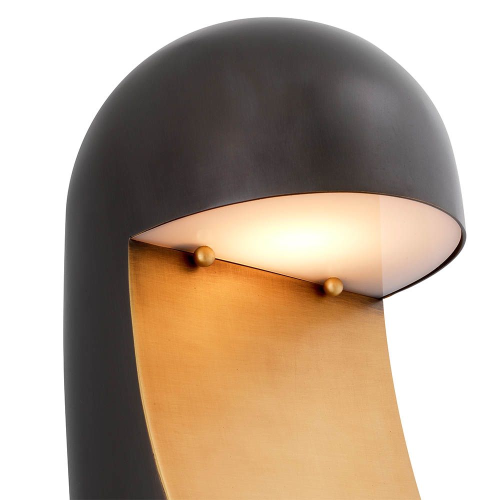 Strikingly modern table lamp with rounded black body and sweeping brass detail