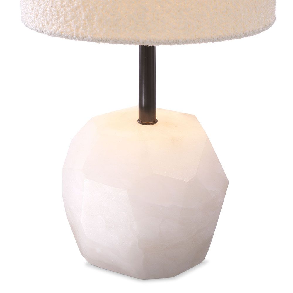 A luxury table lamp by Eichholtz carved from alabaster with an elongated boucle cylindrical shade