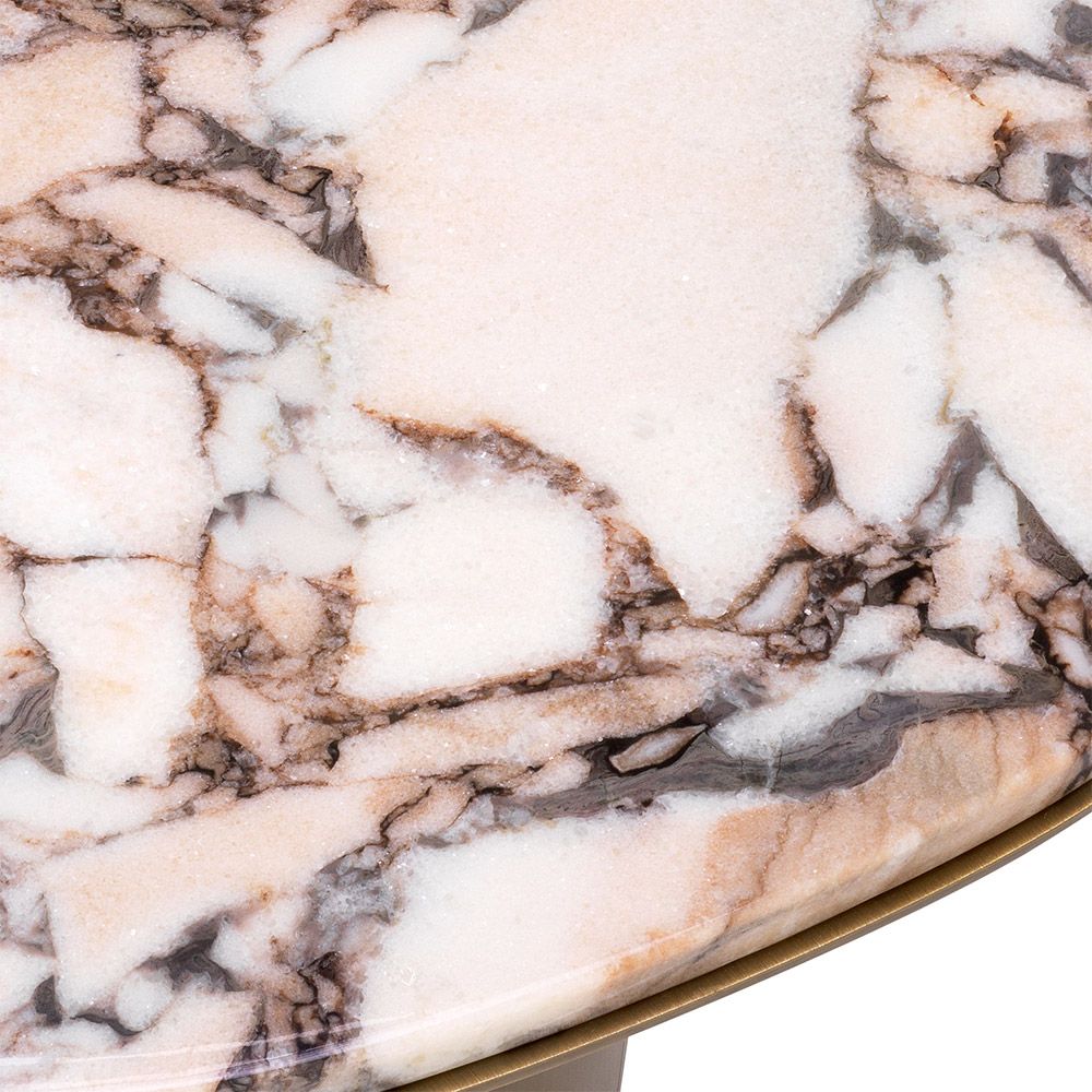 A stainless steel base with a brushed brass finish elegantly supports the asymmetrical marbled top.