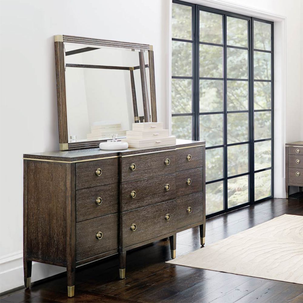 A sophisticated dresser from Bernhardt with a burnished brass and white oak veneer finish, six legs and nine drawers
