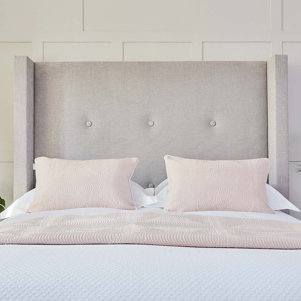 A luxurious minimal bed with deep-buttoning designed exclusively by Sweetpea & Willow