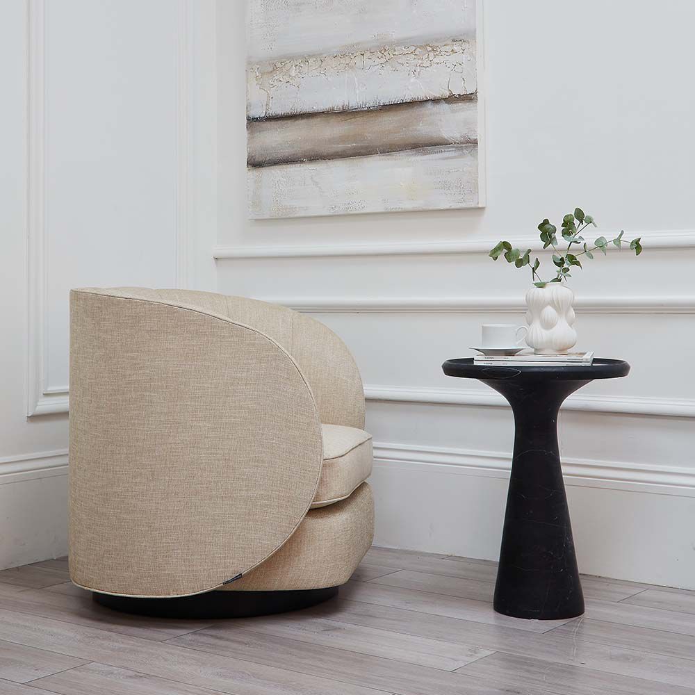 A luxurious linen upholstered swivel chair with accentuating piped details