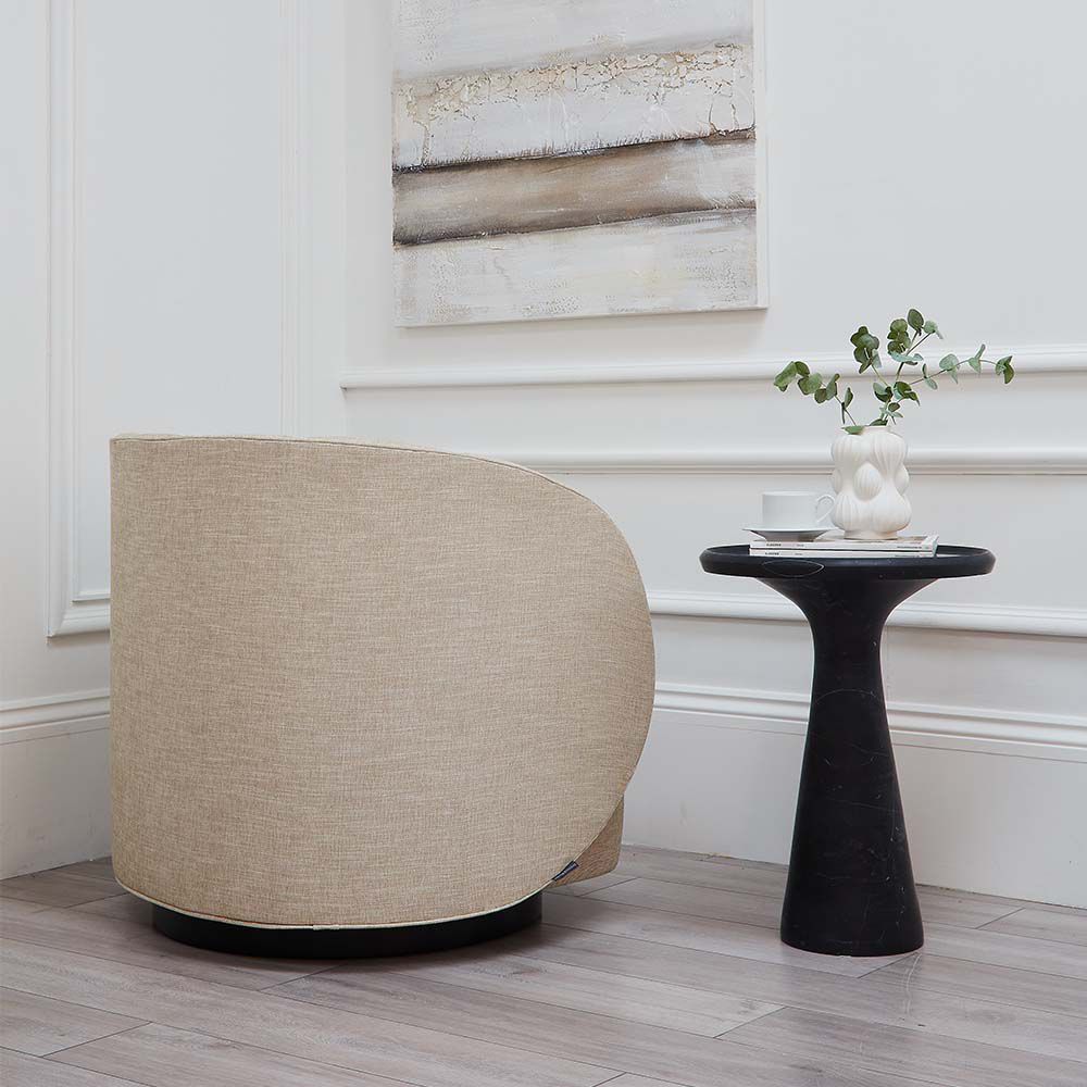 A luxurious linen upholstered swivel chair with accentuating piped details