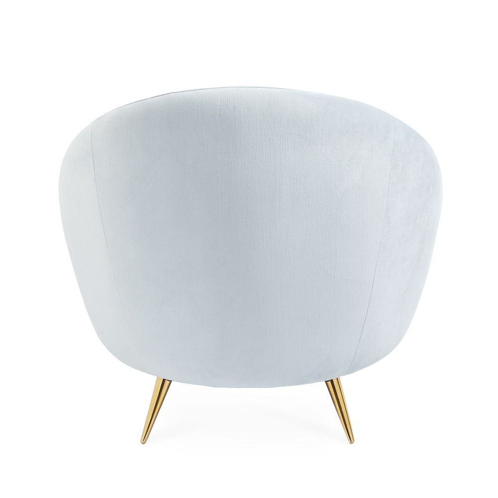 A stylish, modern armchair with light blue velvet upholstery and polished brass legs 