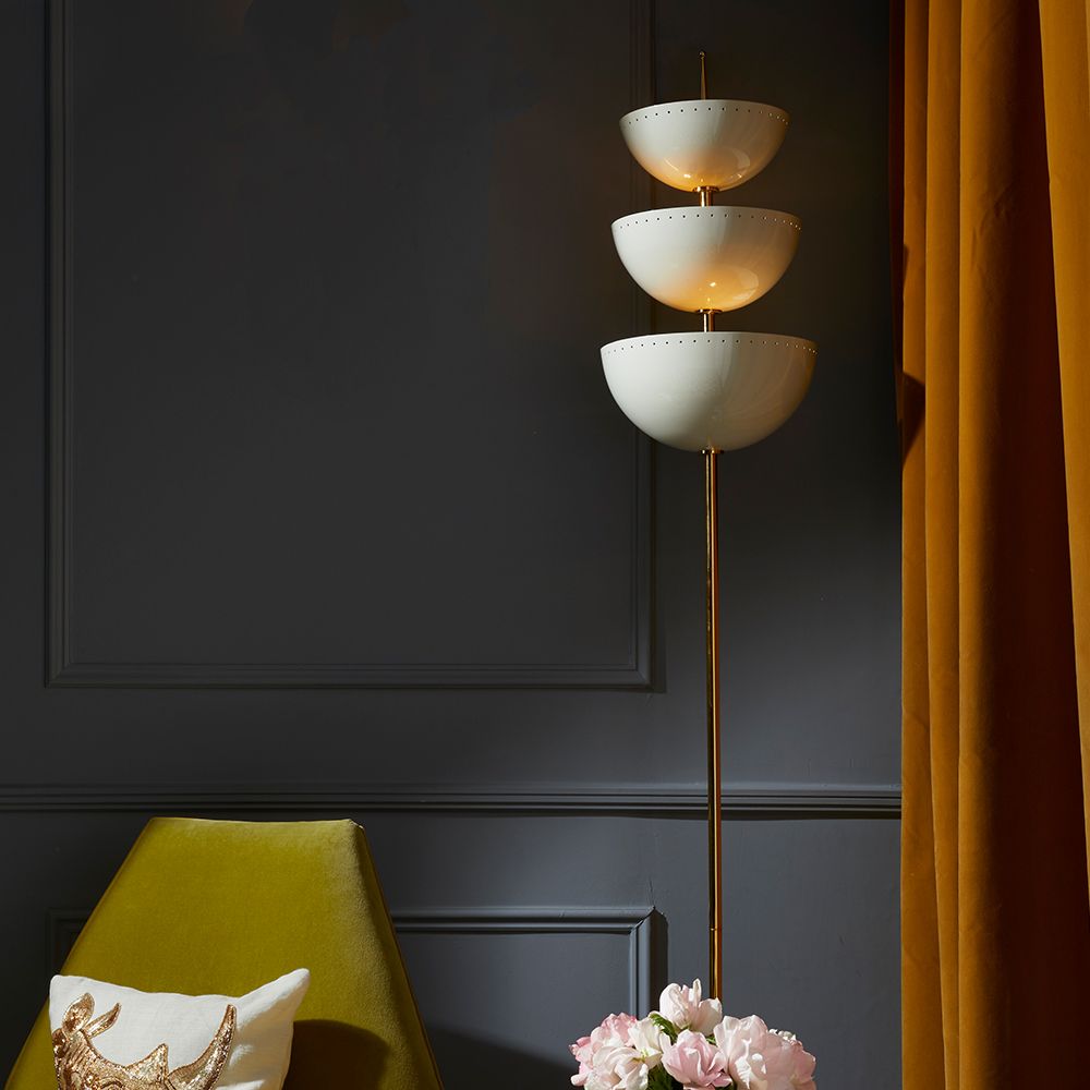 A luxurious floor standing lamp with ivory metal, polished brass and a marble base