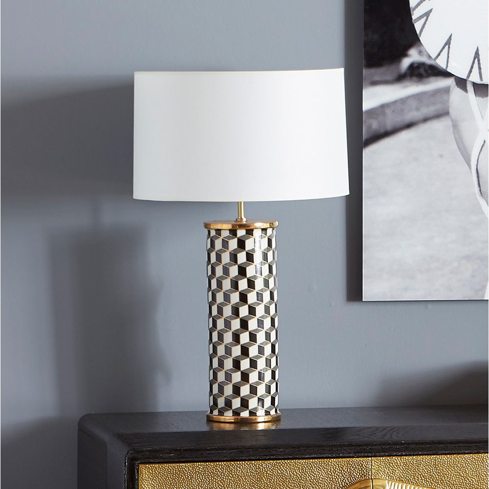 A stylish, porcelain table lamp with a chic geometric pattern and brass accents 