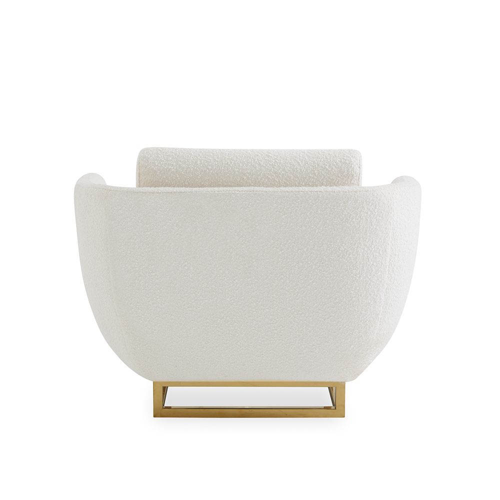 modern luxe armchair with ivory boucle upholstery and polished brass base