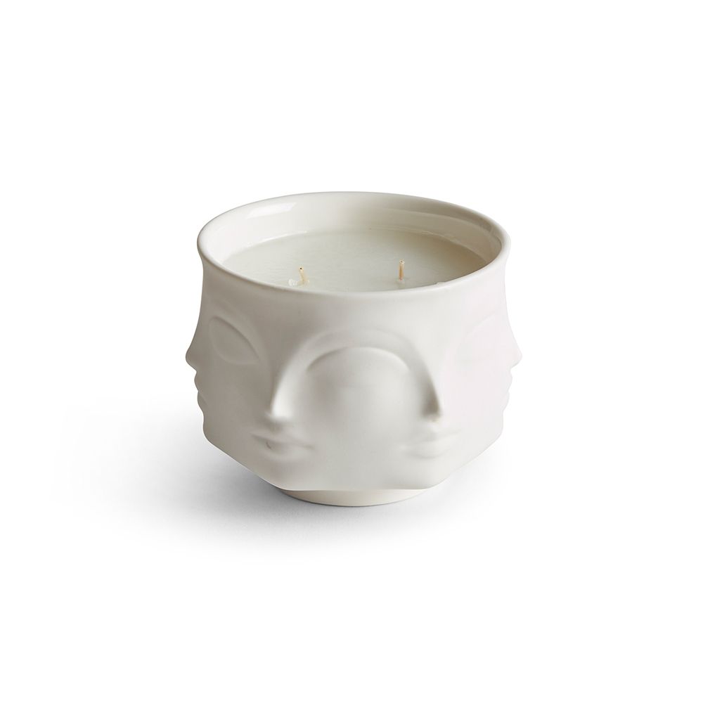 white ceramic candle decorated with faces