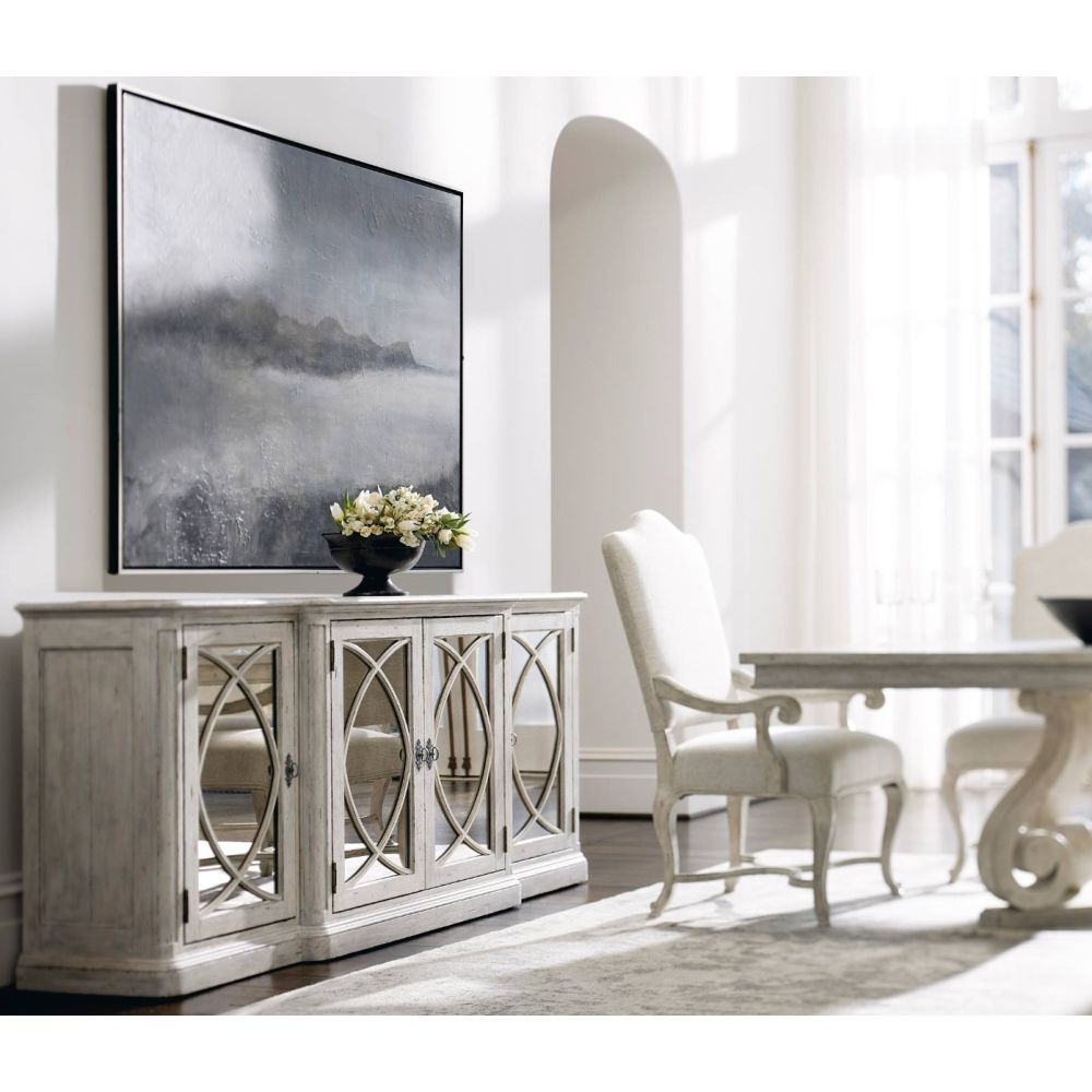 Elegant, distressed sideboard with decorated panel doors.