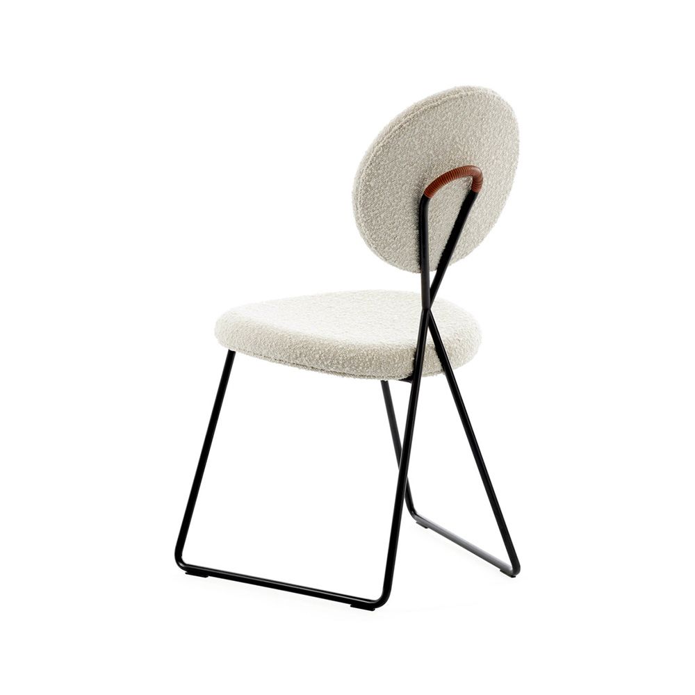 Stylish dining chair upholstered in white fabric with a sleek black frame