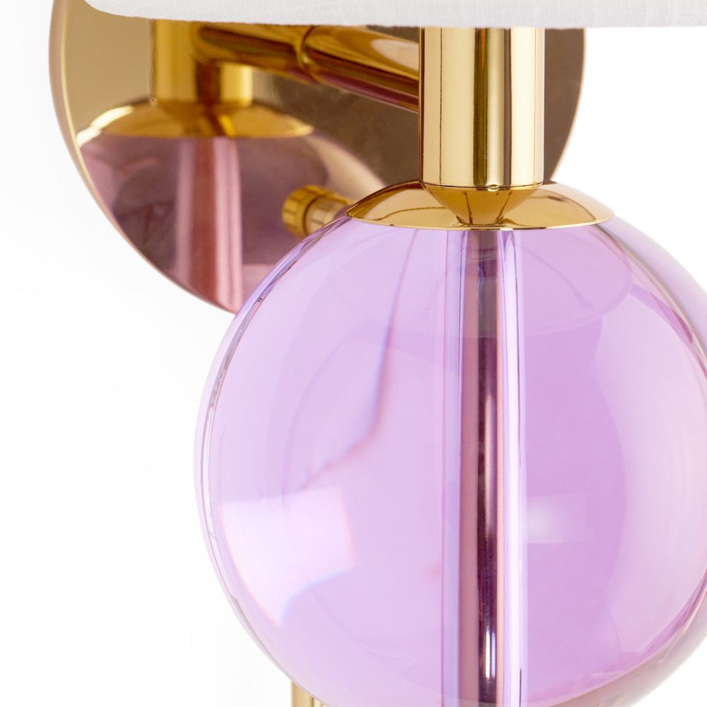 Opulent wall light with vibrant purple sphere and brass accents