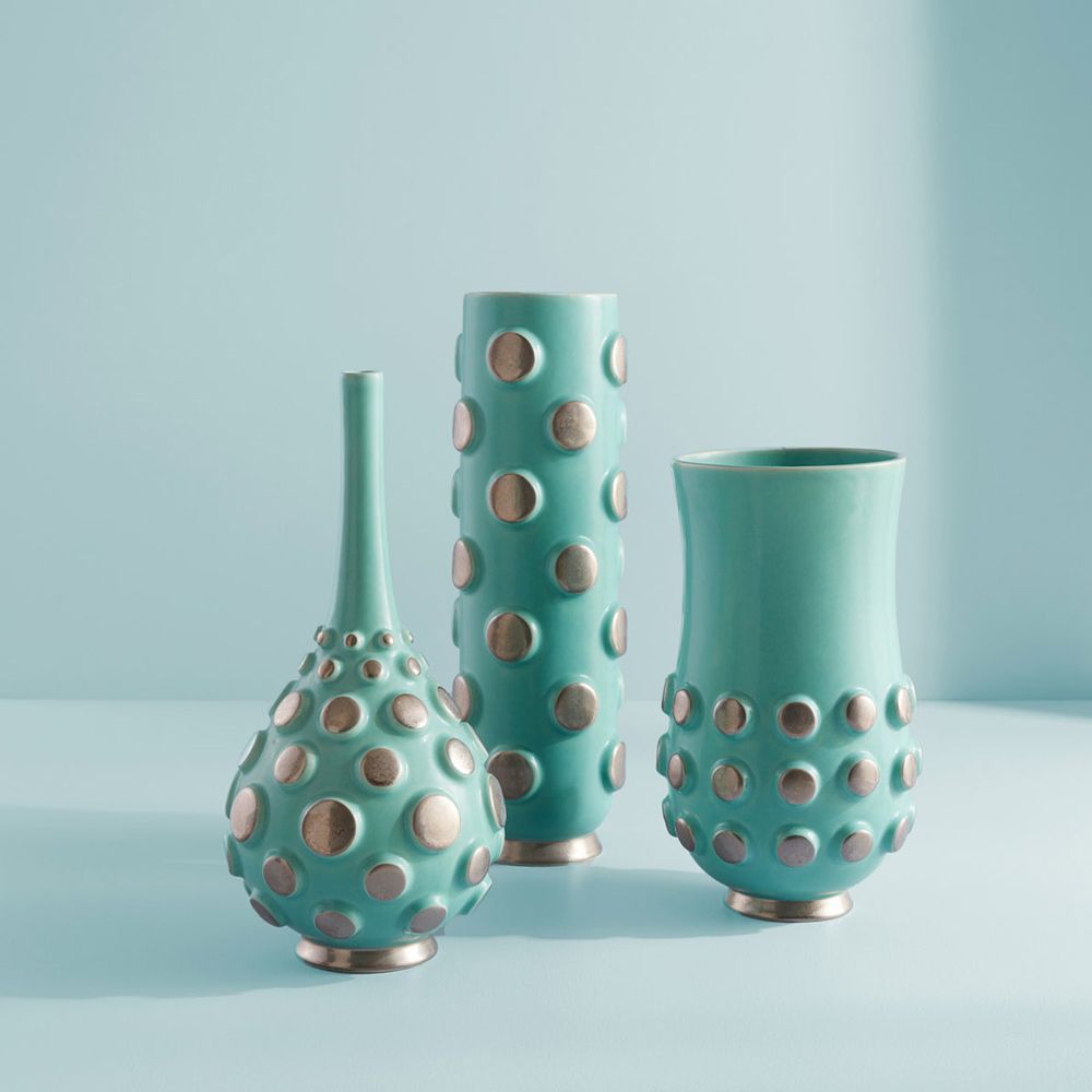 An eye-catching, sea-inspired vase by Jonathan Adler featuring a beautiful blue colour and metallic details