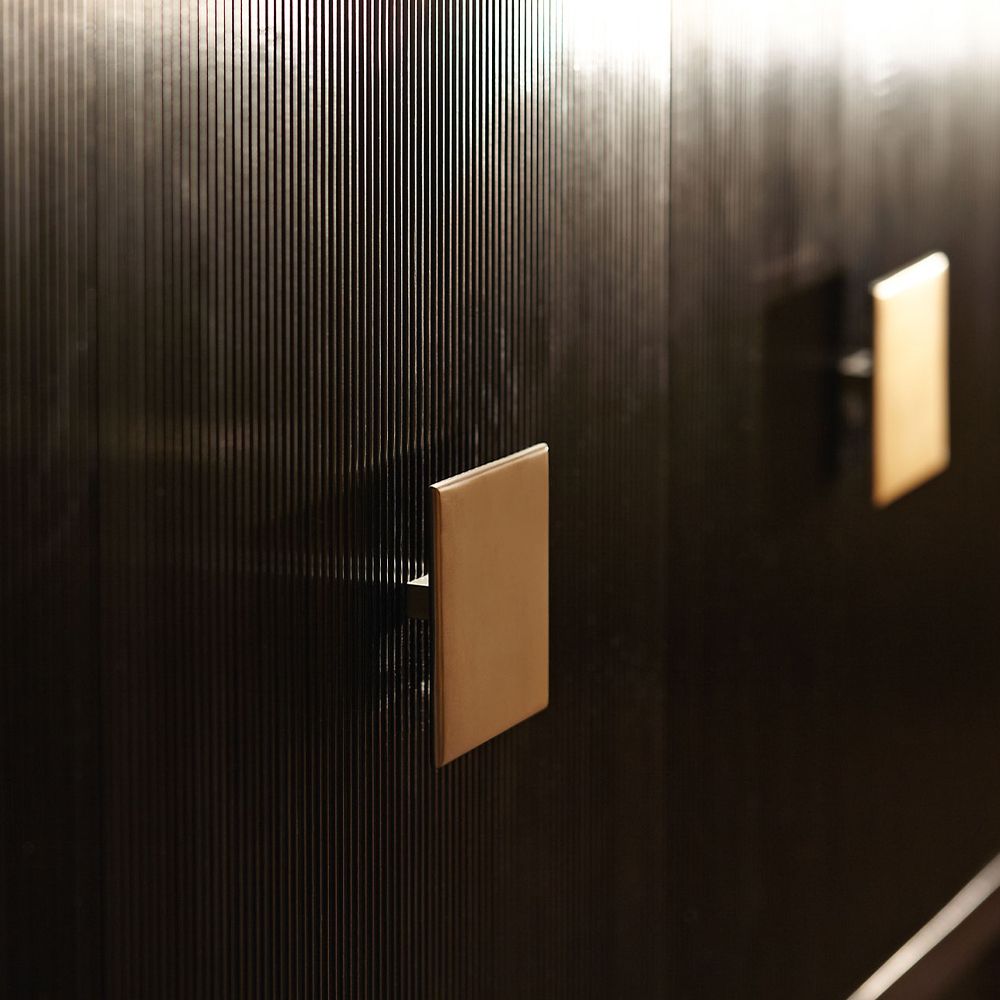 A classic dark brown textured 4 door buffet with brass square handles