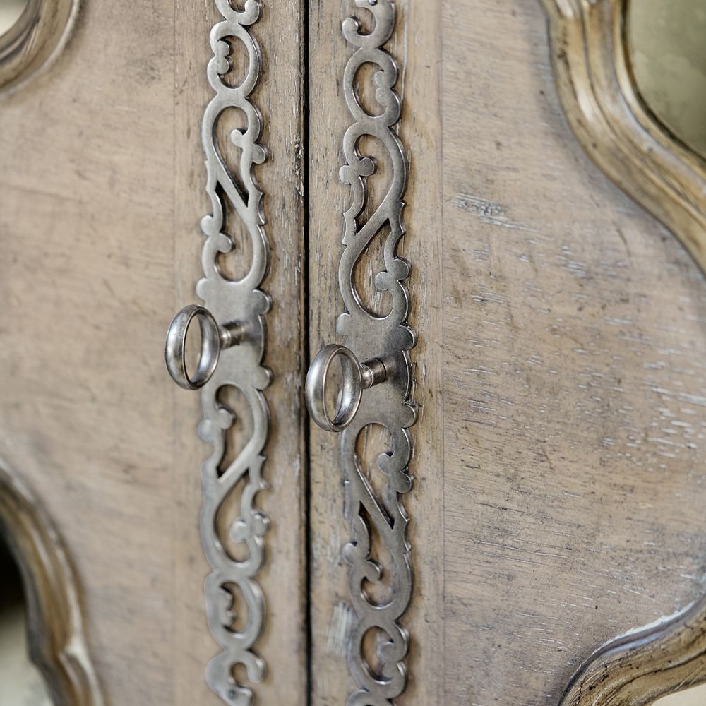 A beautiful armoire by Bernhardt featuring two wood-framed doors with antique mirrored glass panels