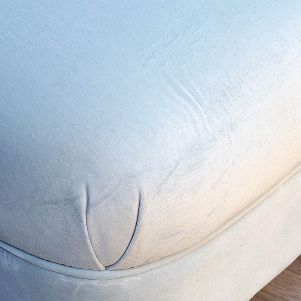 A curvaceous chaise longue with a pale blue velvet upholstery and seashell-like frame 