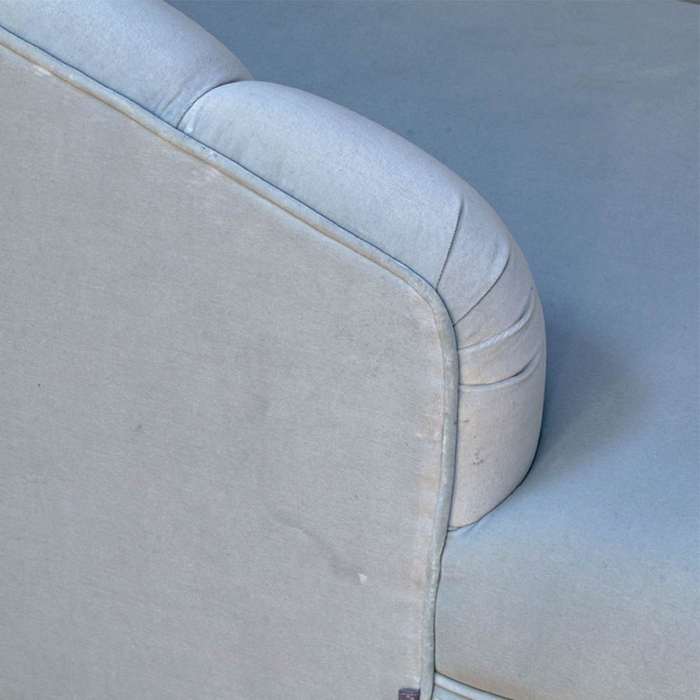 A curvaceous chaise longue with a pale blue velvet upholstery and seashell-like frame 