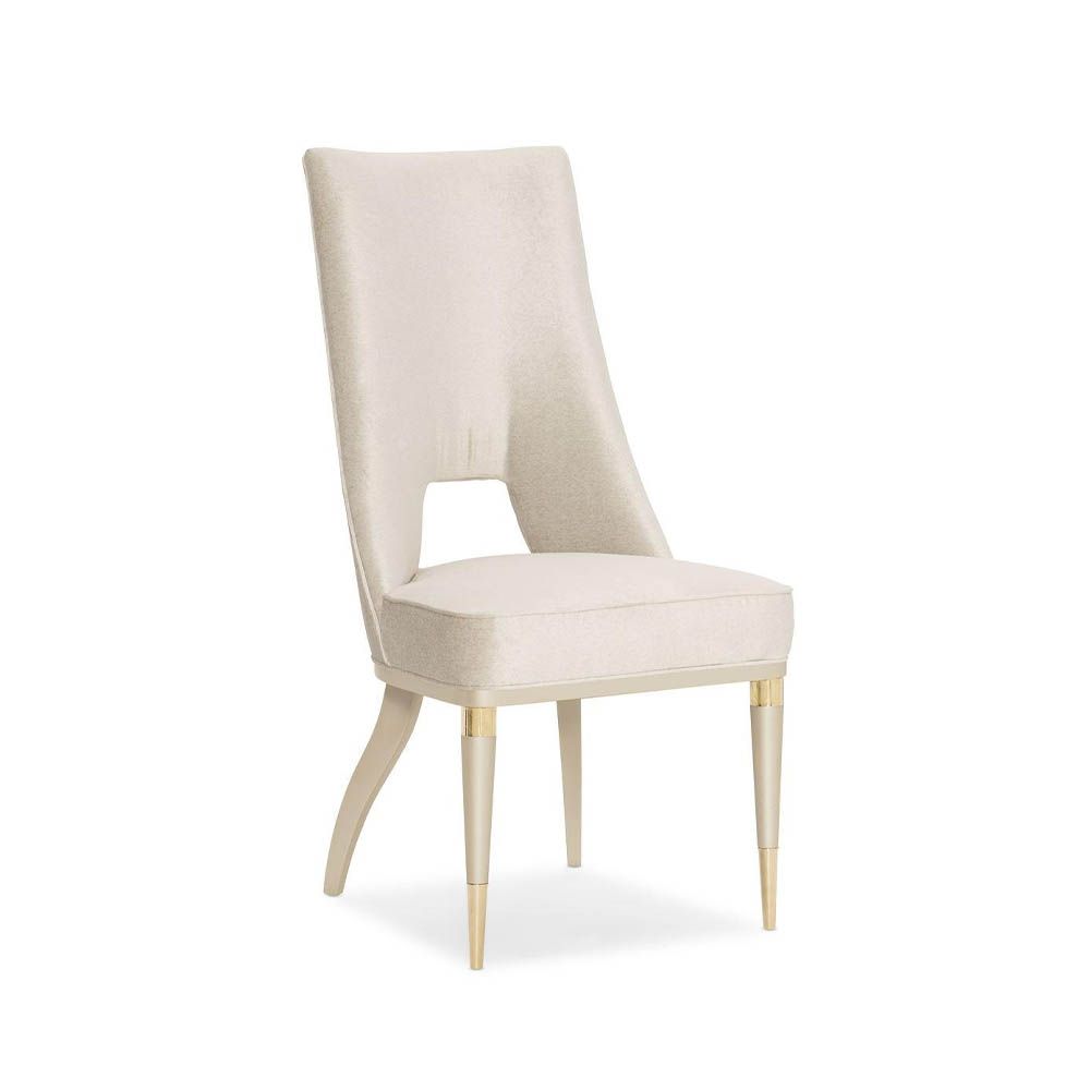 Neutral upholstered dining room chair with peak-through lower back
