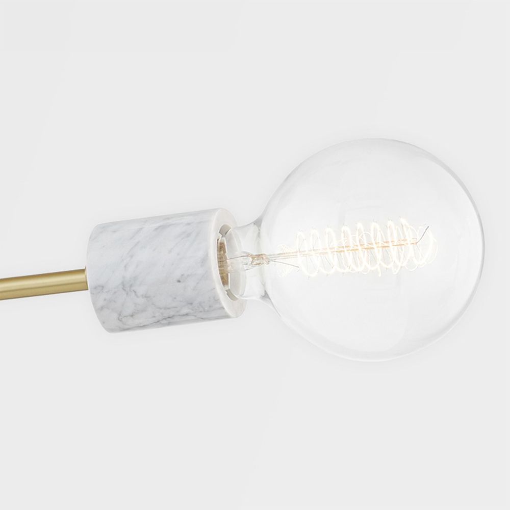 A chic white marble and aged brass dual globe wall lamp