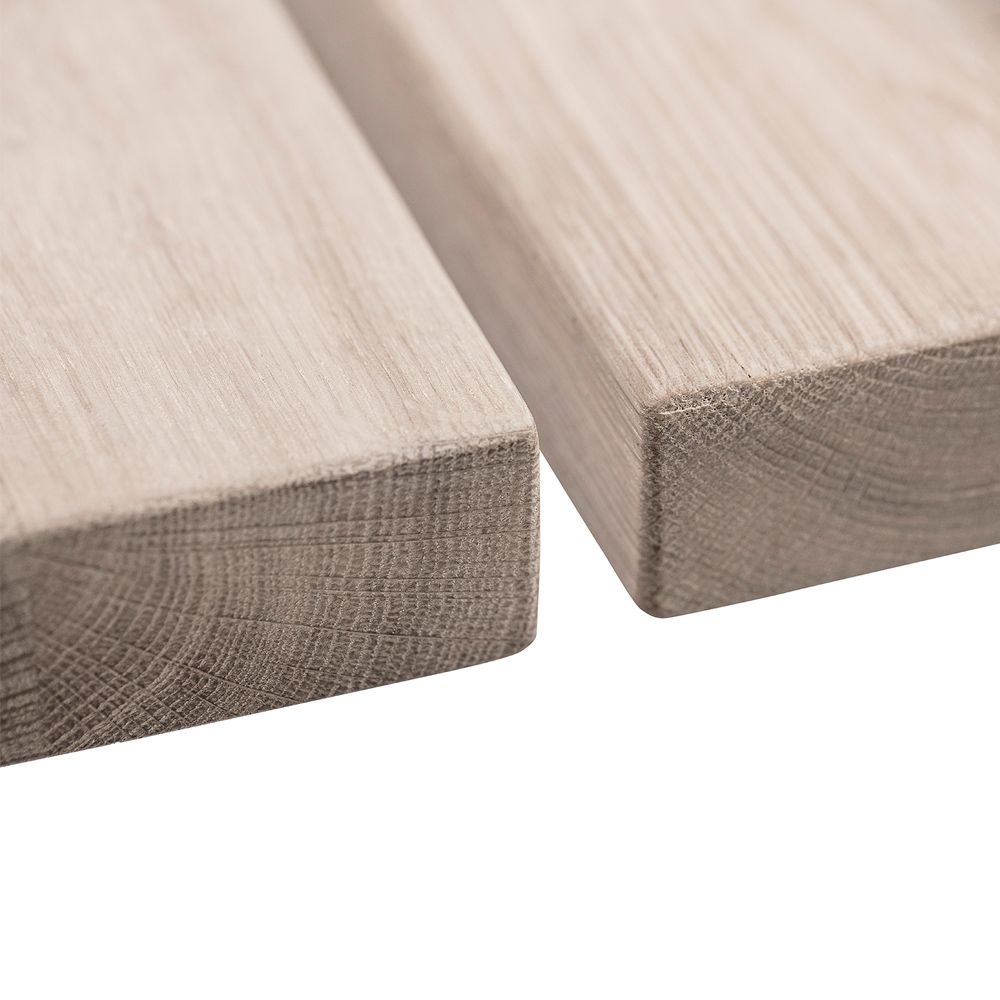 A stylish natural oak dining table with white iron legs
