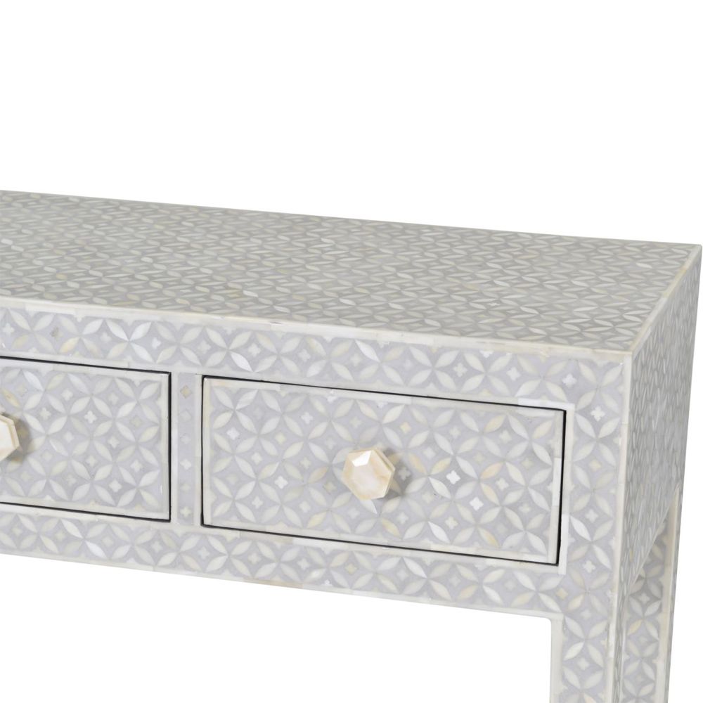 A luxurious grey console table with bone inlay details