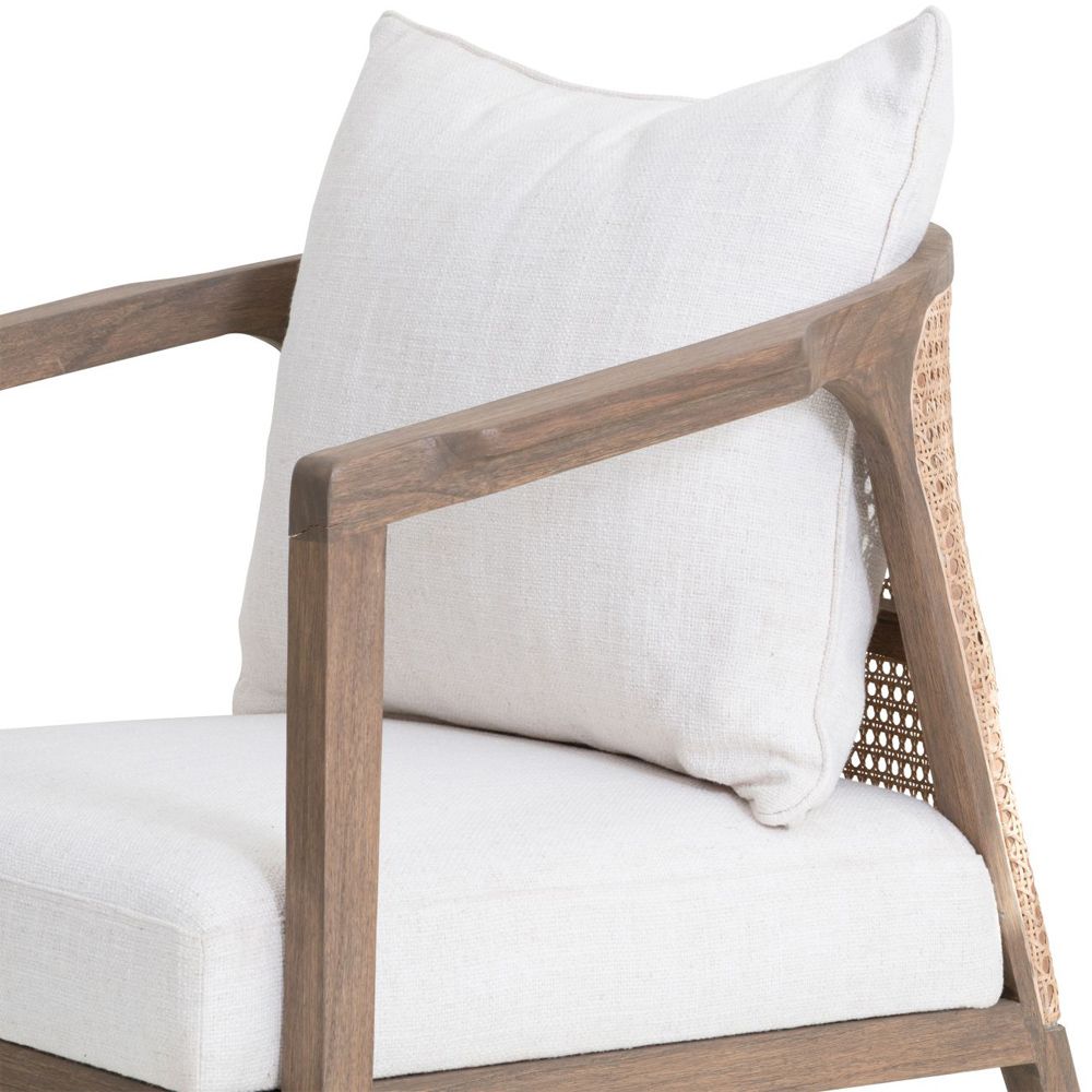 A luxurious mindi wood chair with off-white upholstery and a rattan backrest