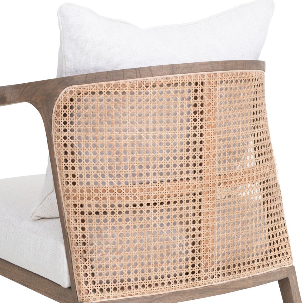 A luxurious mindi wood chair with off-white upholstery and a rattan backrest