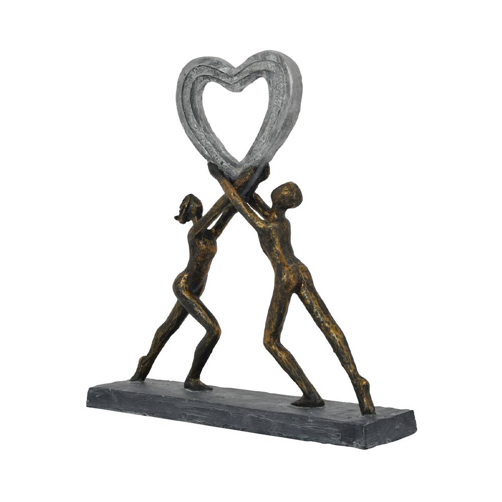 A beautiful, dark bronze sculpture of two figures holding up a heart which embodies love 