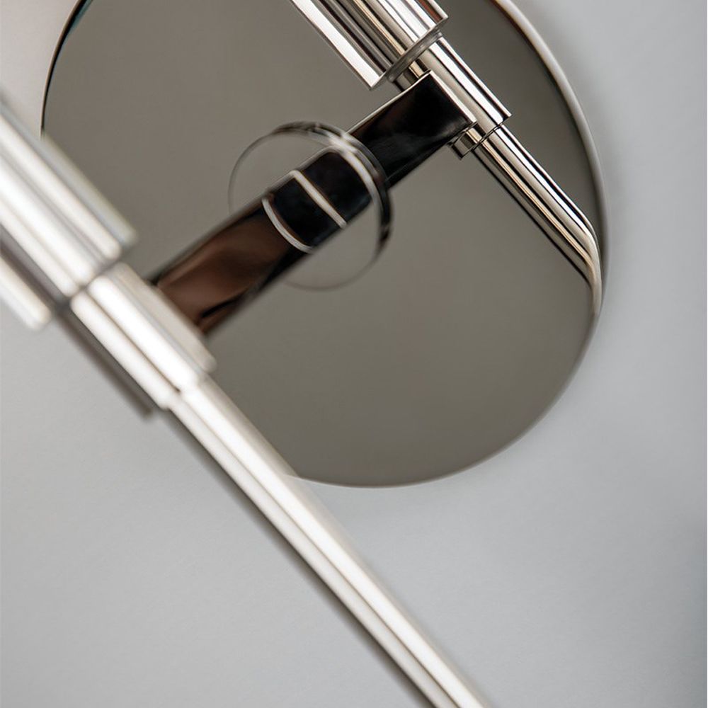 A sophisticated contemporary-style wall sconce in polished nickel with an off white shade