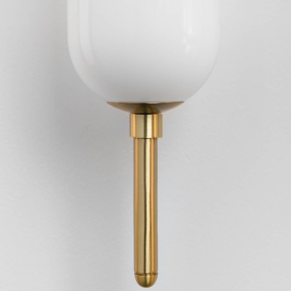 Luxurious brass wall light with opal coloured glass