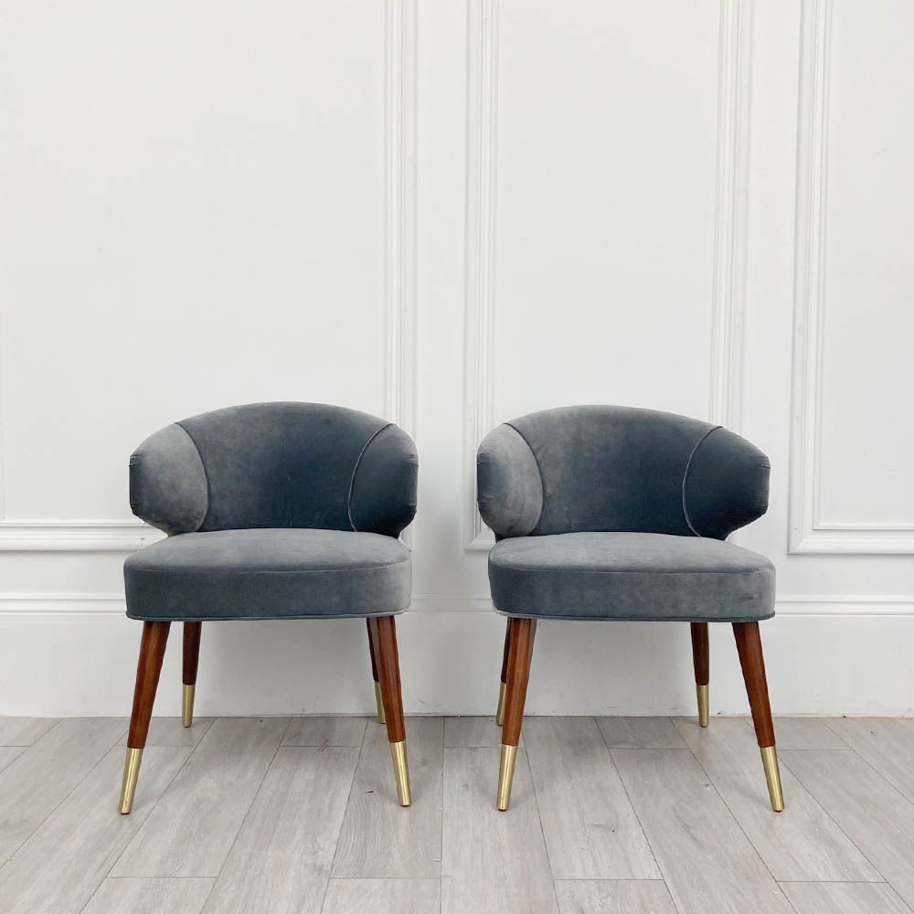 A sumptuous blue-grey velvet dining chair with hand-applied studs