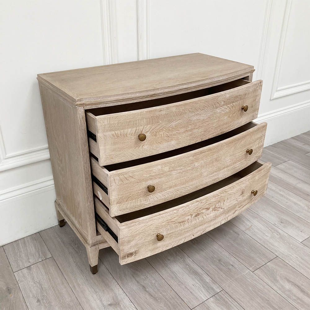 A stunning natural whitewash oak three-drawer chest with brass details