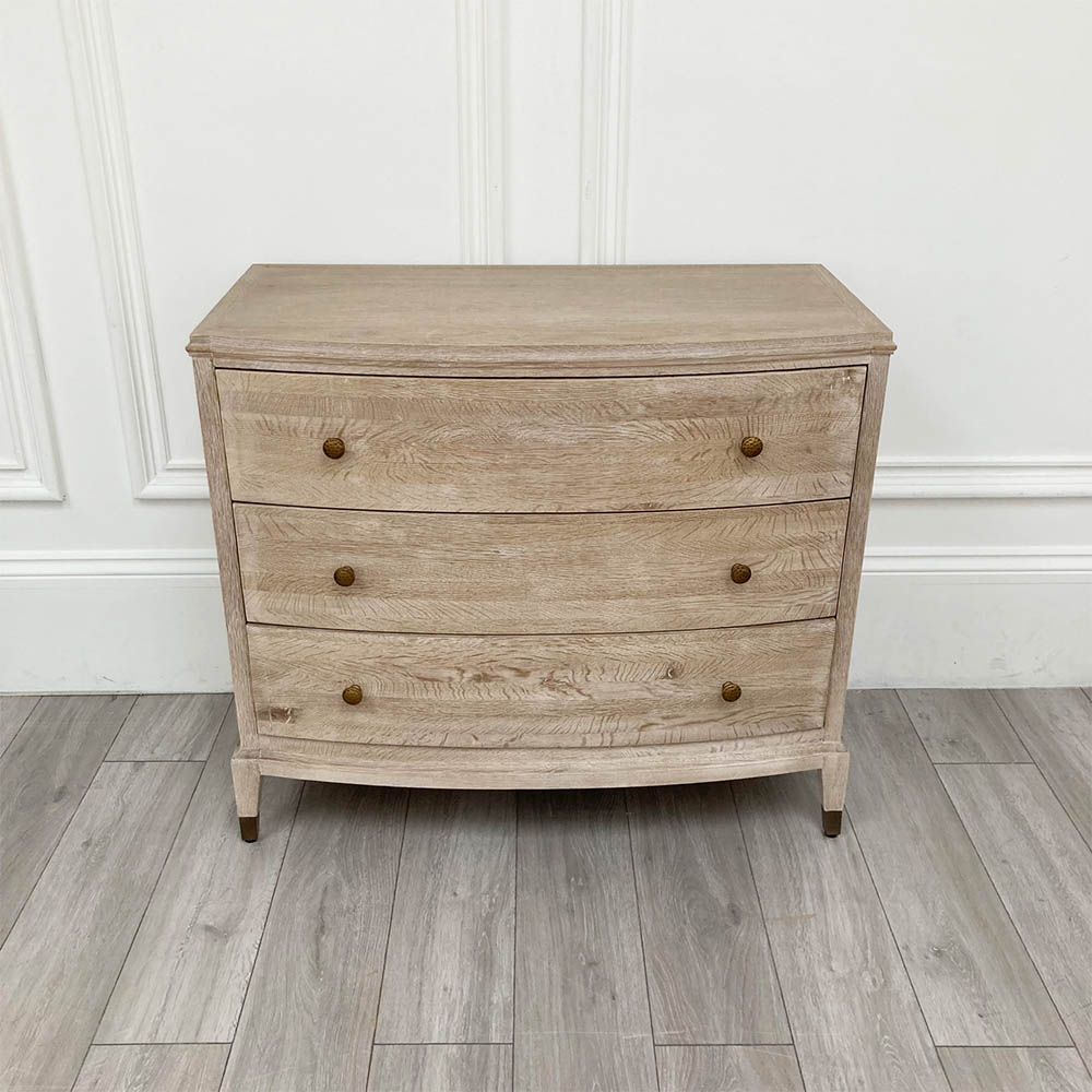 A stunning natural whitewash oak three-drawer chest with brass details