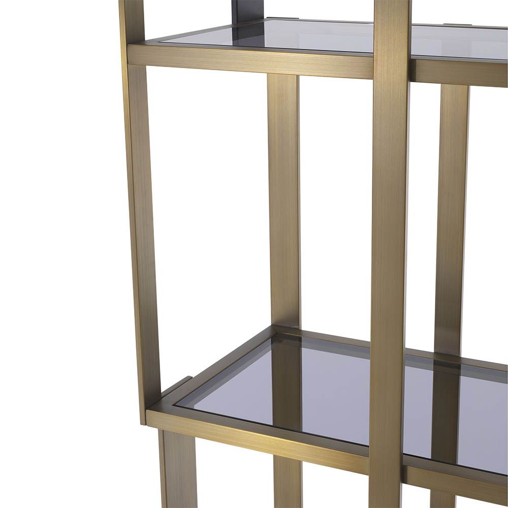 Elegant and glamorous shelving unit finished in brushed brass with geometric design