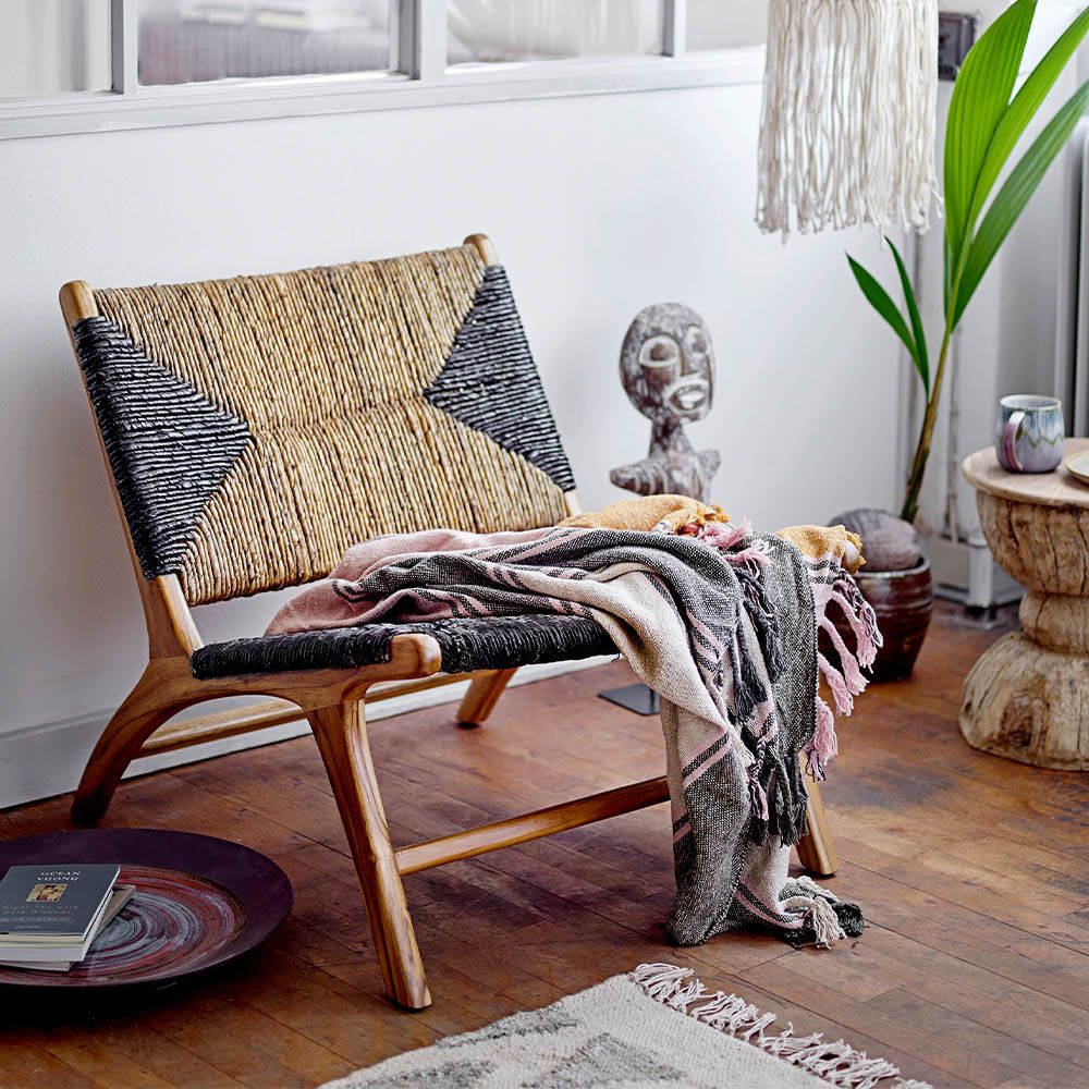 Enchanting laid-back lounge chair with black graphic pattern and natural textures.