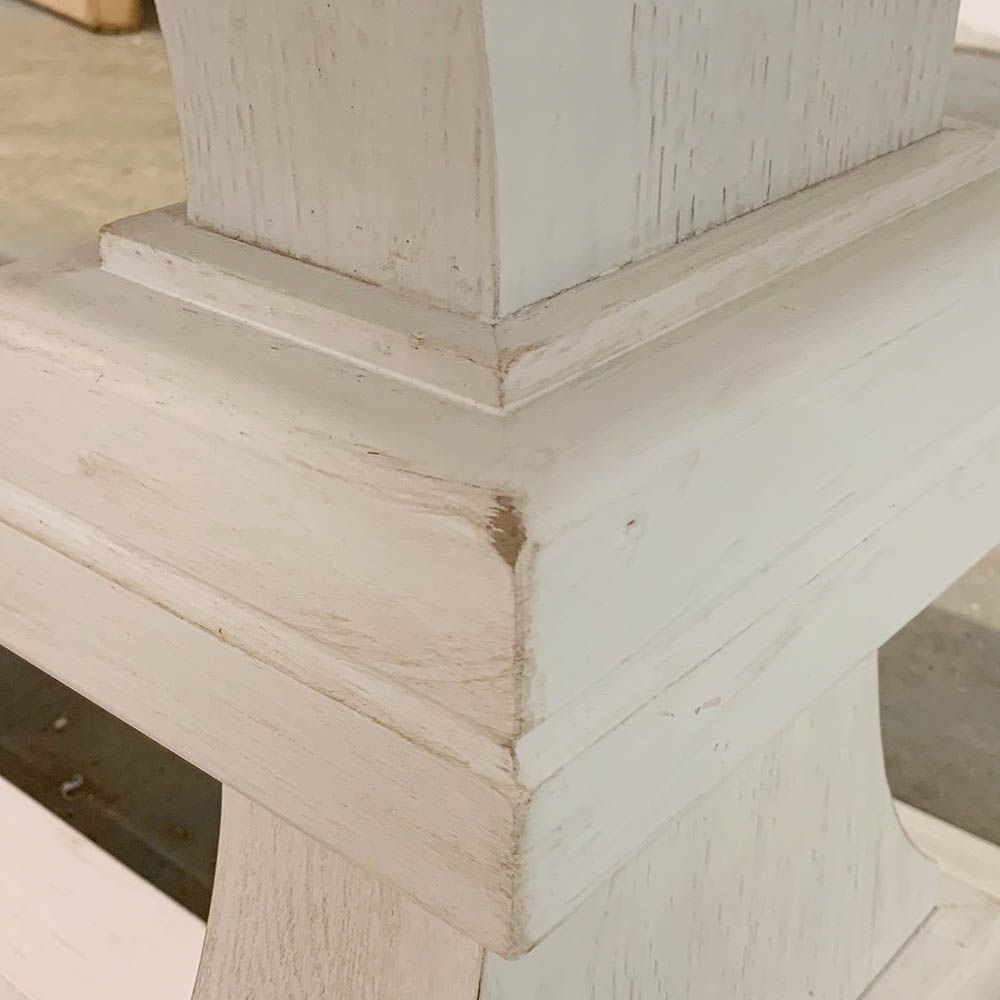 Imperfections to the brushed white finish of the corner of the table