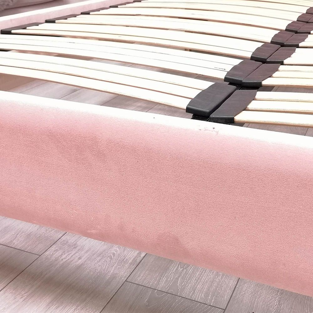 Gorgeous, statement kingsize bed with rounded, fluted headboard and blossom coloured upholstery